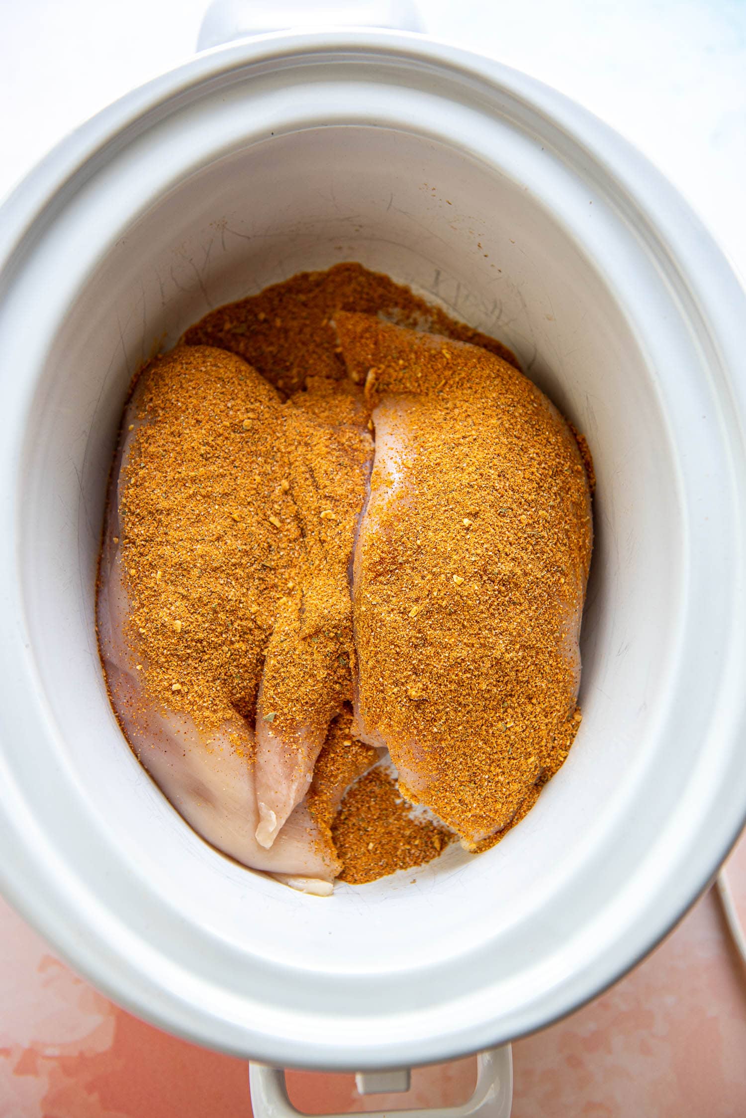 chicken breasts with taco seasoning in slow cooker