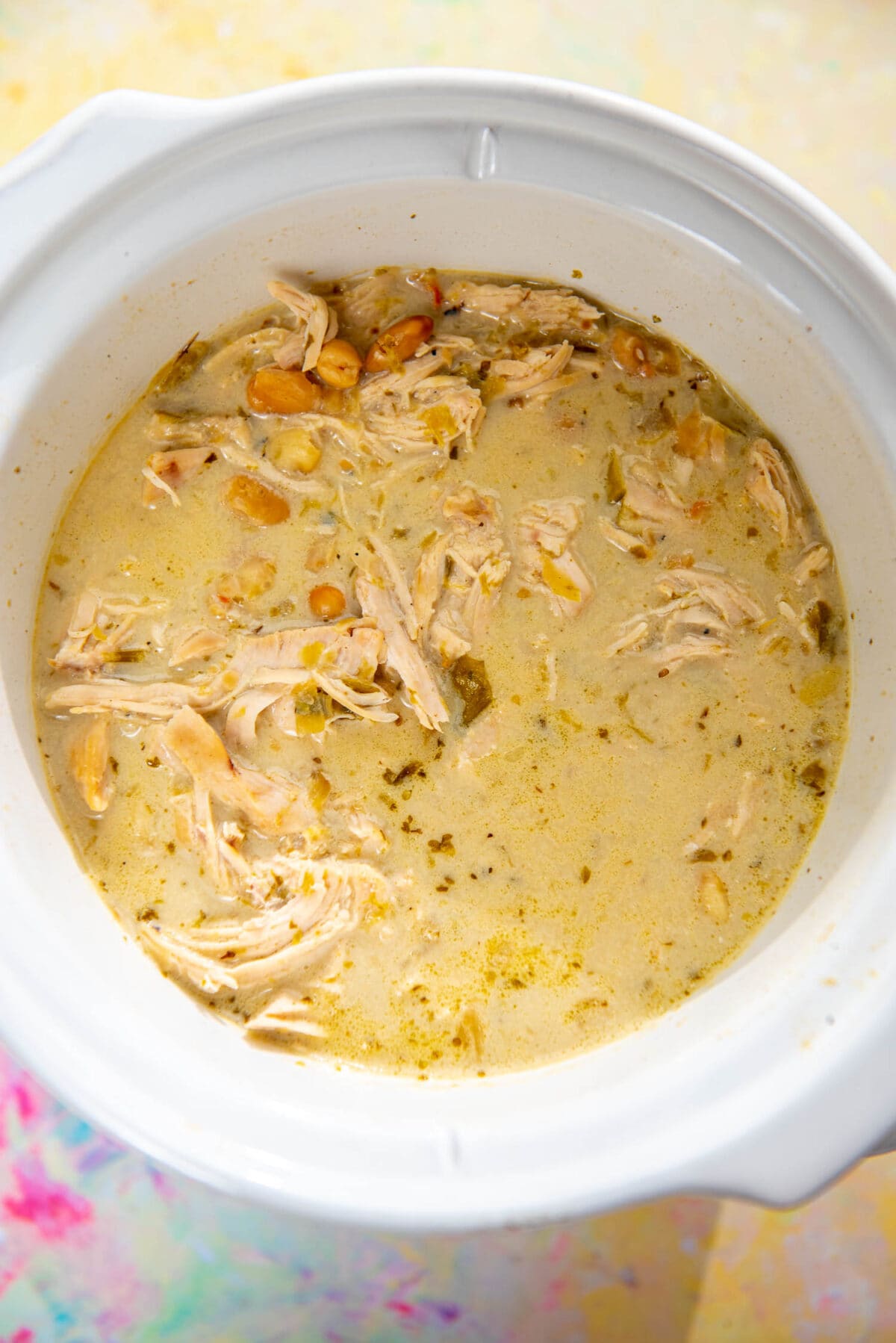 round white slow cooker filled with creamy white chicken chili