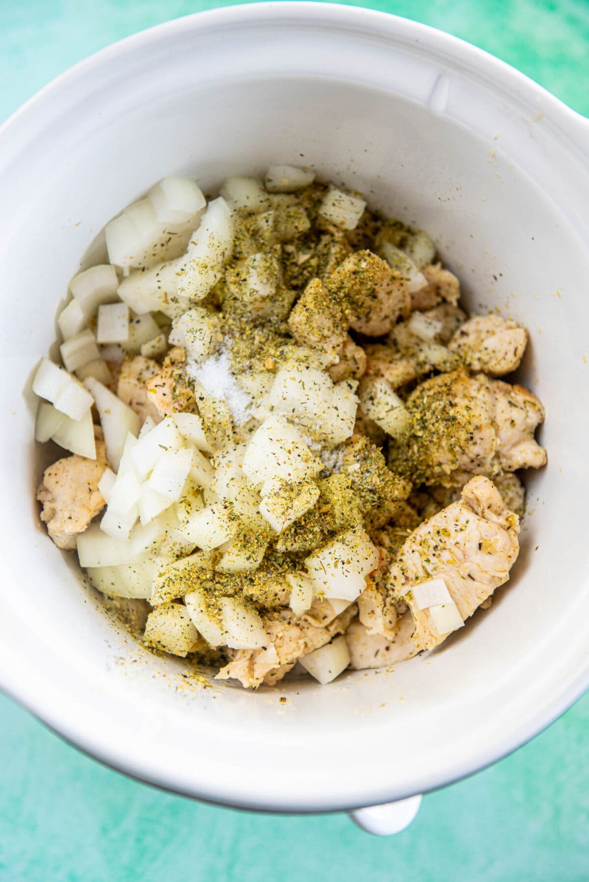 chicken, onions and seasoning in slow cooker