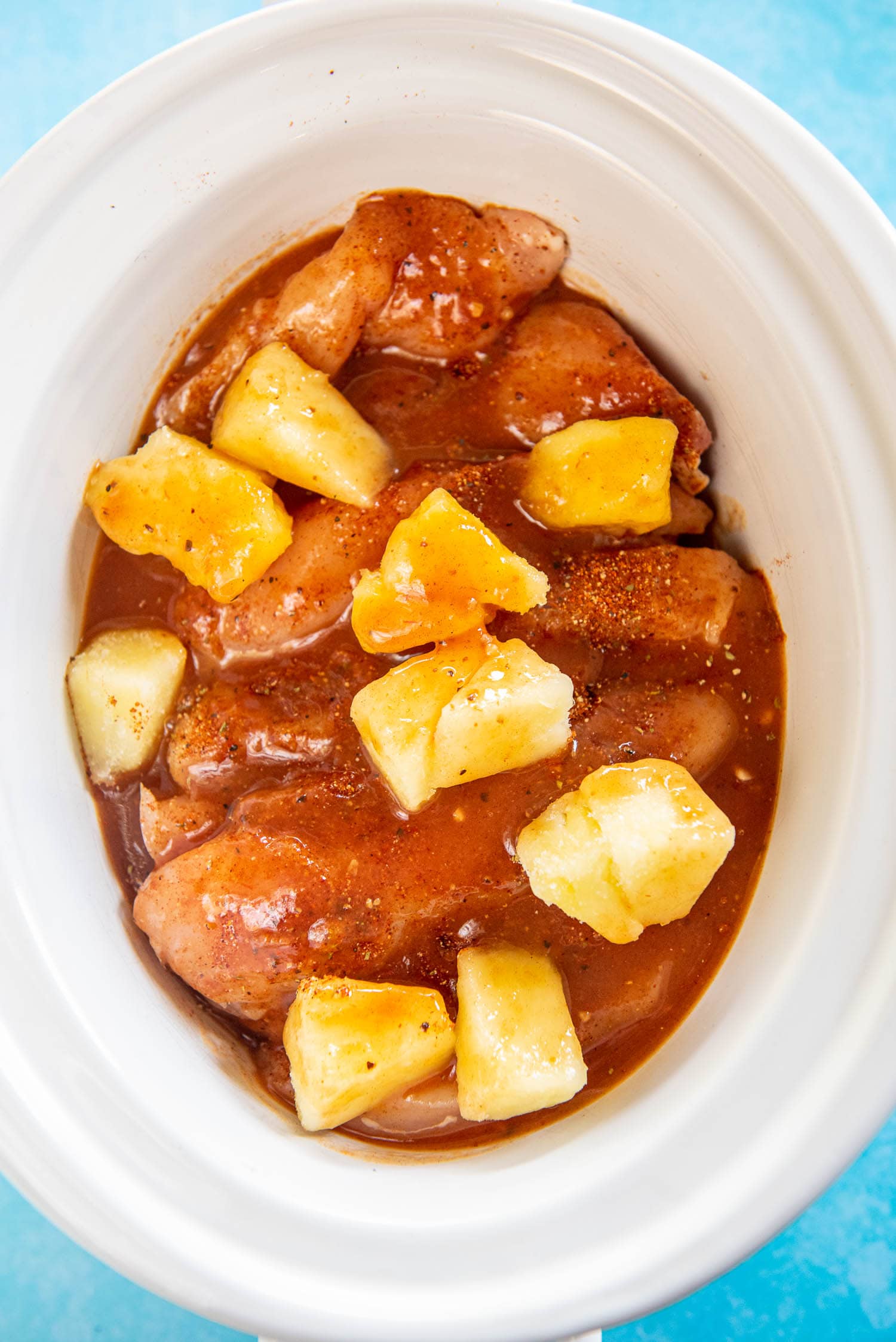 chicken, pineapple and sauce in slow cooker