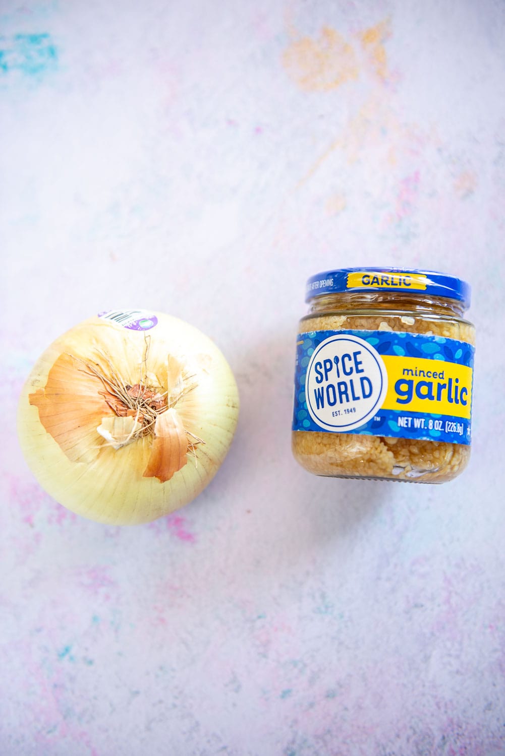 yellow onion and jar of minced garlic