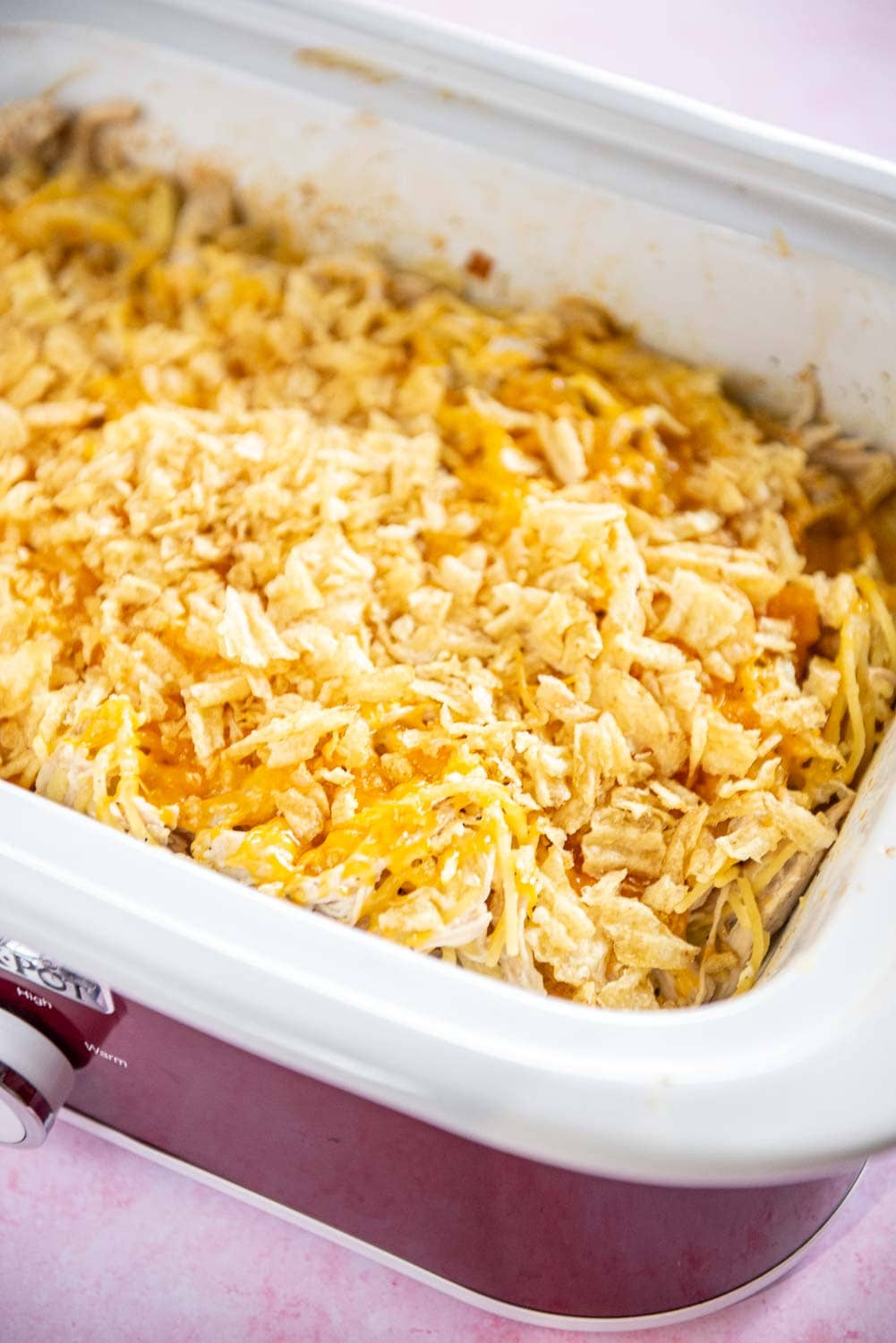 Slow Cooker Chicken Noodle Casserole cooked inside of a red slow cooker crock pot