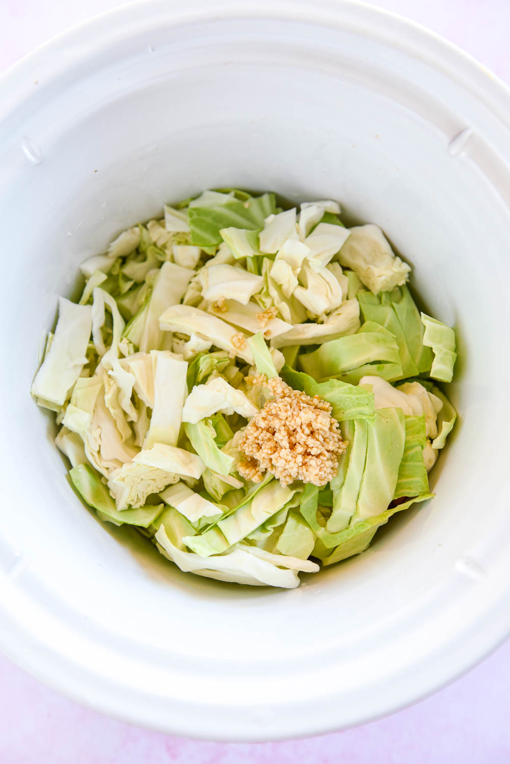 chopped cabbage and garlic in slow cooker