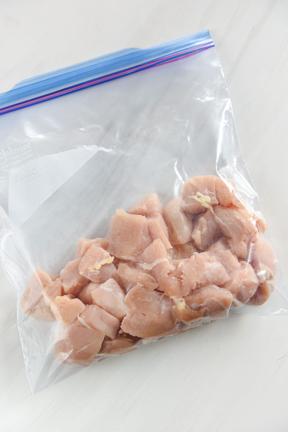 Freezer bag with cut up chicken breasts