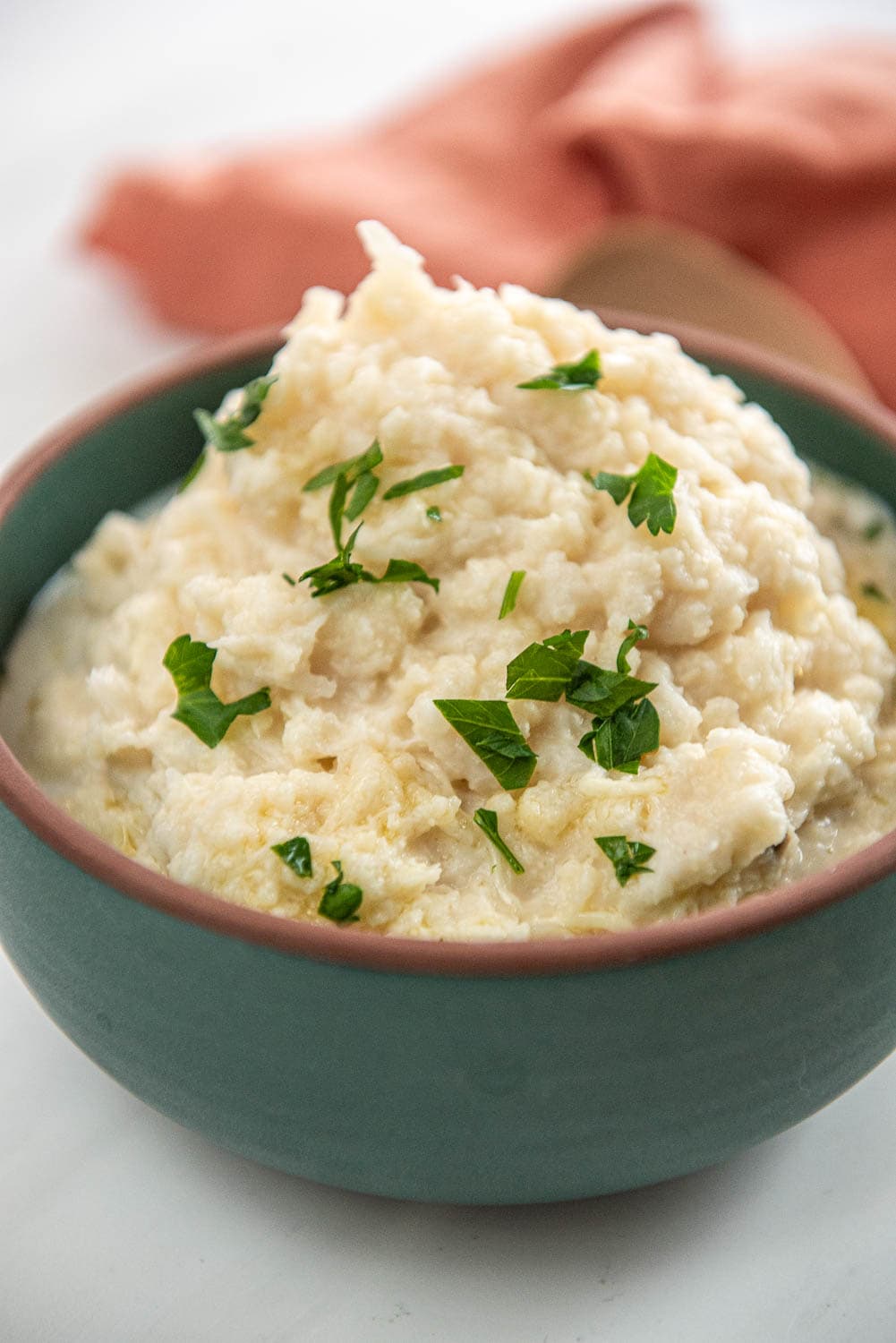 green bowl filled with mashed cauliflower