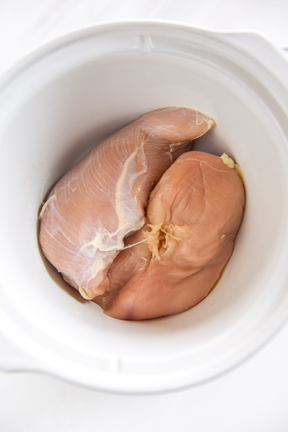 raw chicken breasts in slow cooker