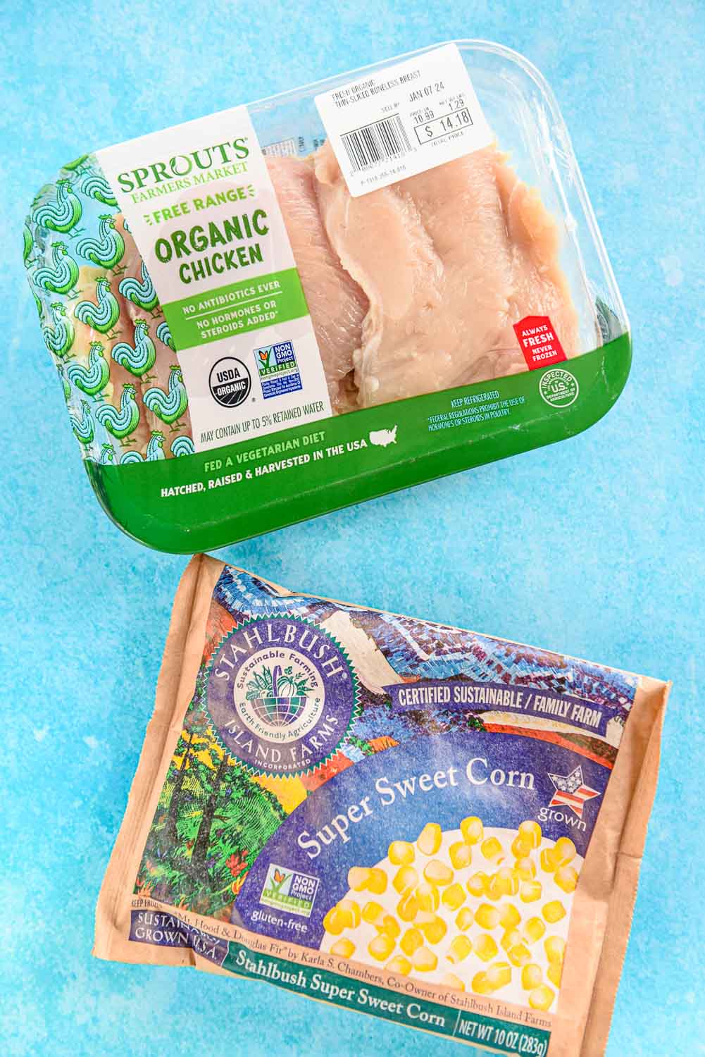 package of chicken breasts and package of frozen corn kernels