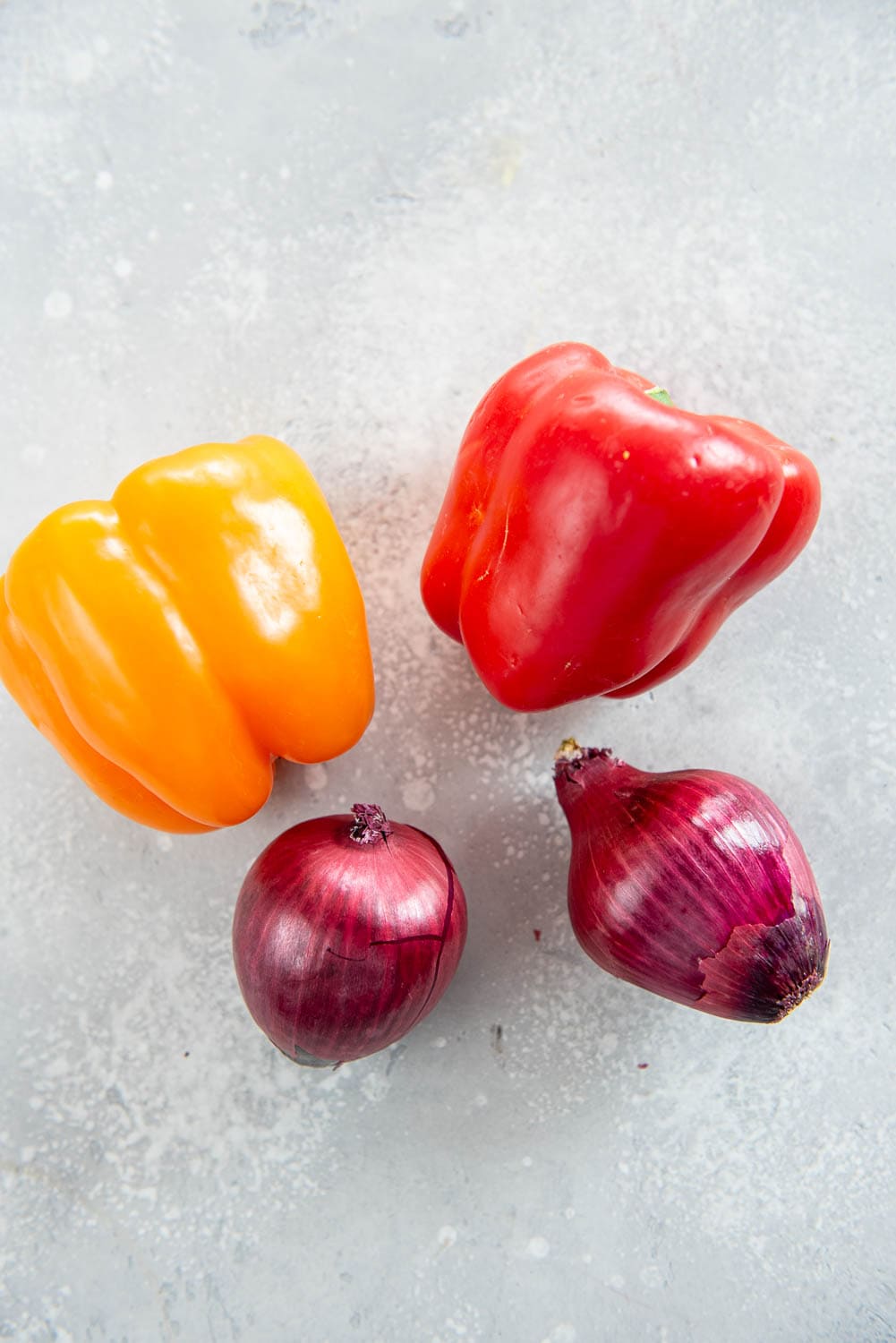 orange bell pepper, red bell pepper, two small red onions