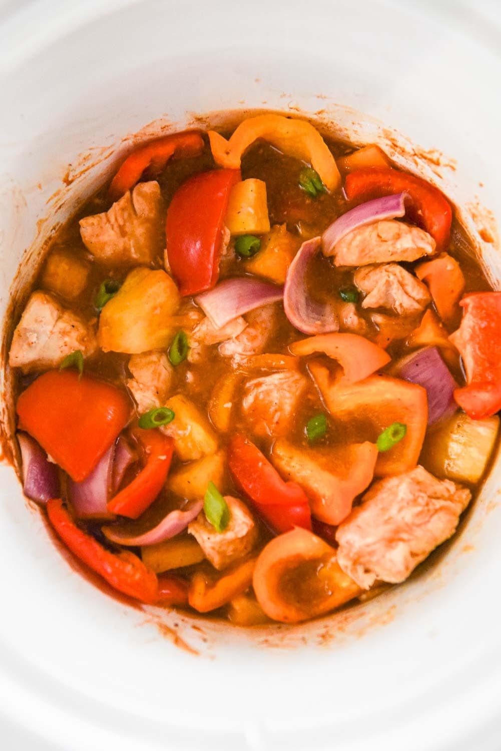 slow cooker with pineapple chicken and peppers and onions