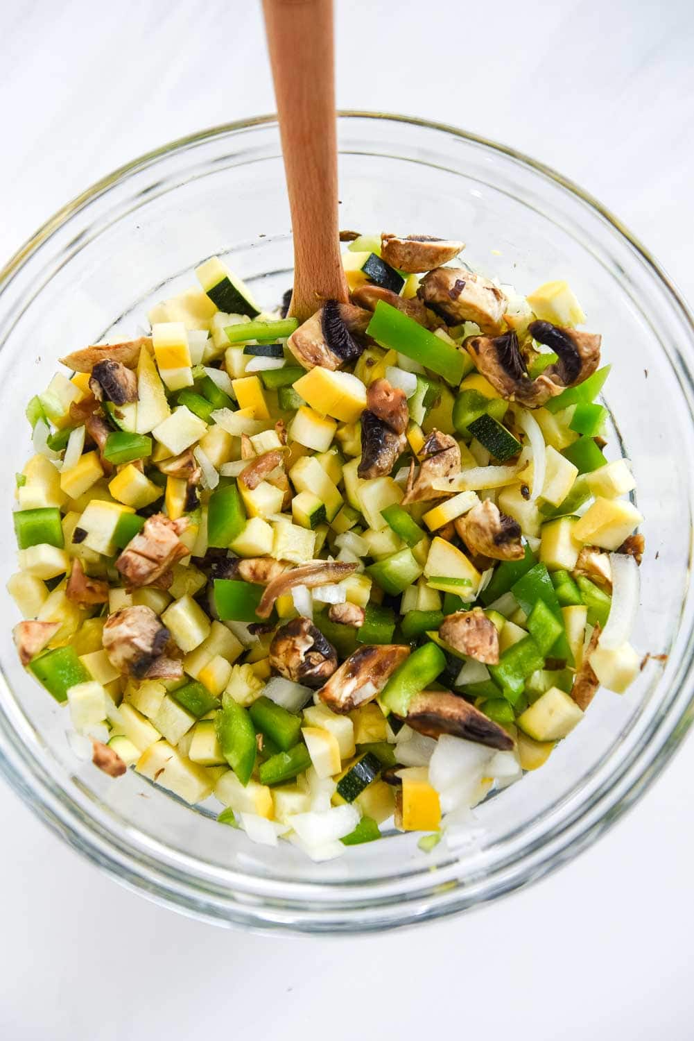 chopped squash, peppers and mushrooms in glass bowl
