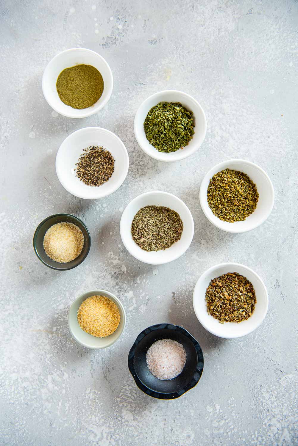 variety of seasonings and spices in 9 small bowls