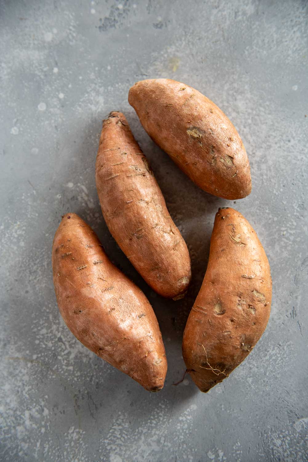4 sweet potatoes on table