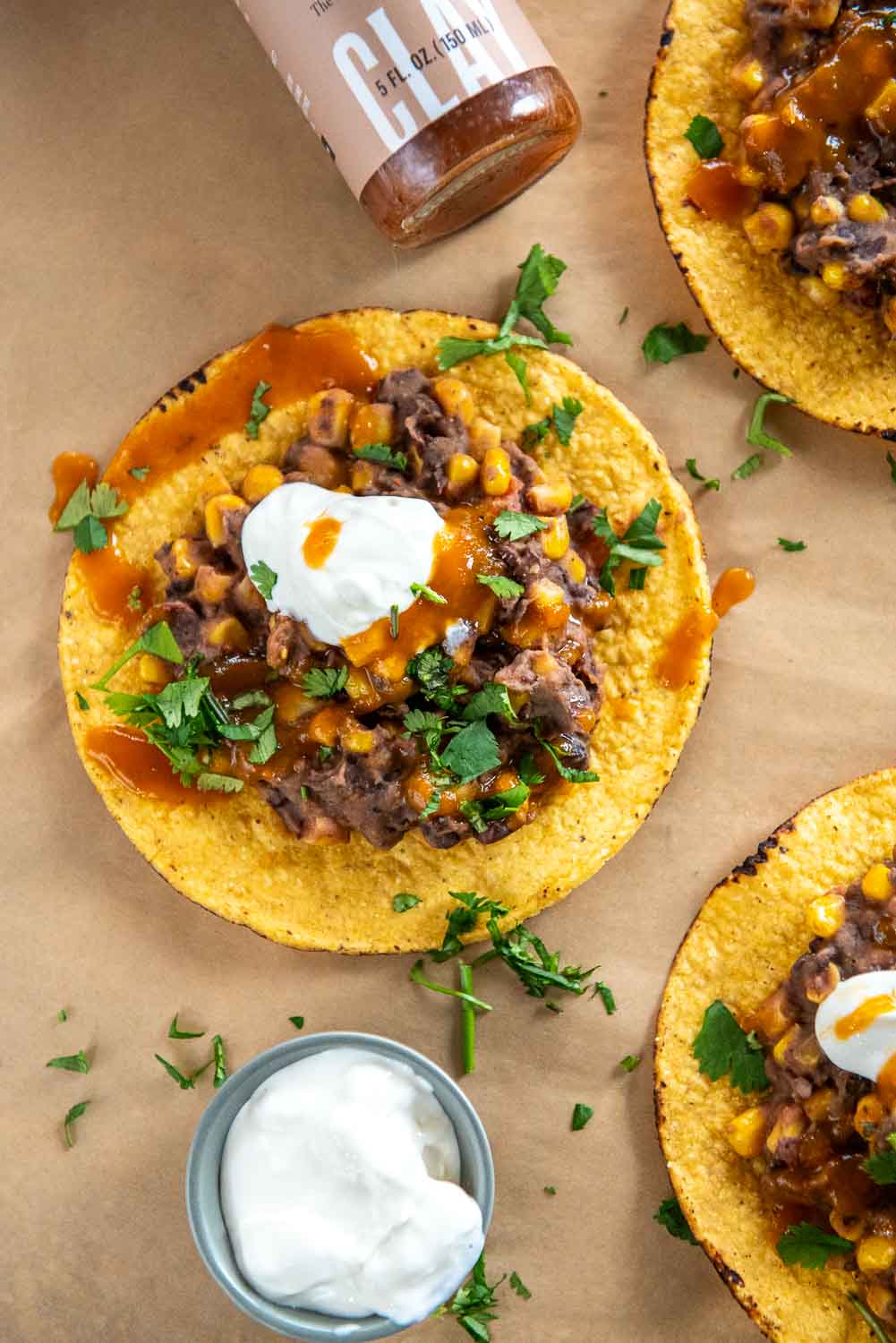Slow Cooker Black Bean Corn and Basil Tostadas served with a side sour cream