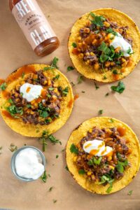 Slow Cooker Black Bean Corn and Basil Tostadas with a habanero hot sauce on side