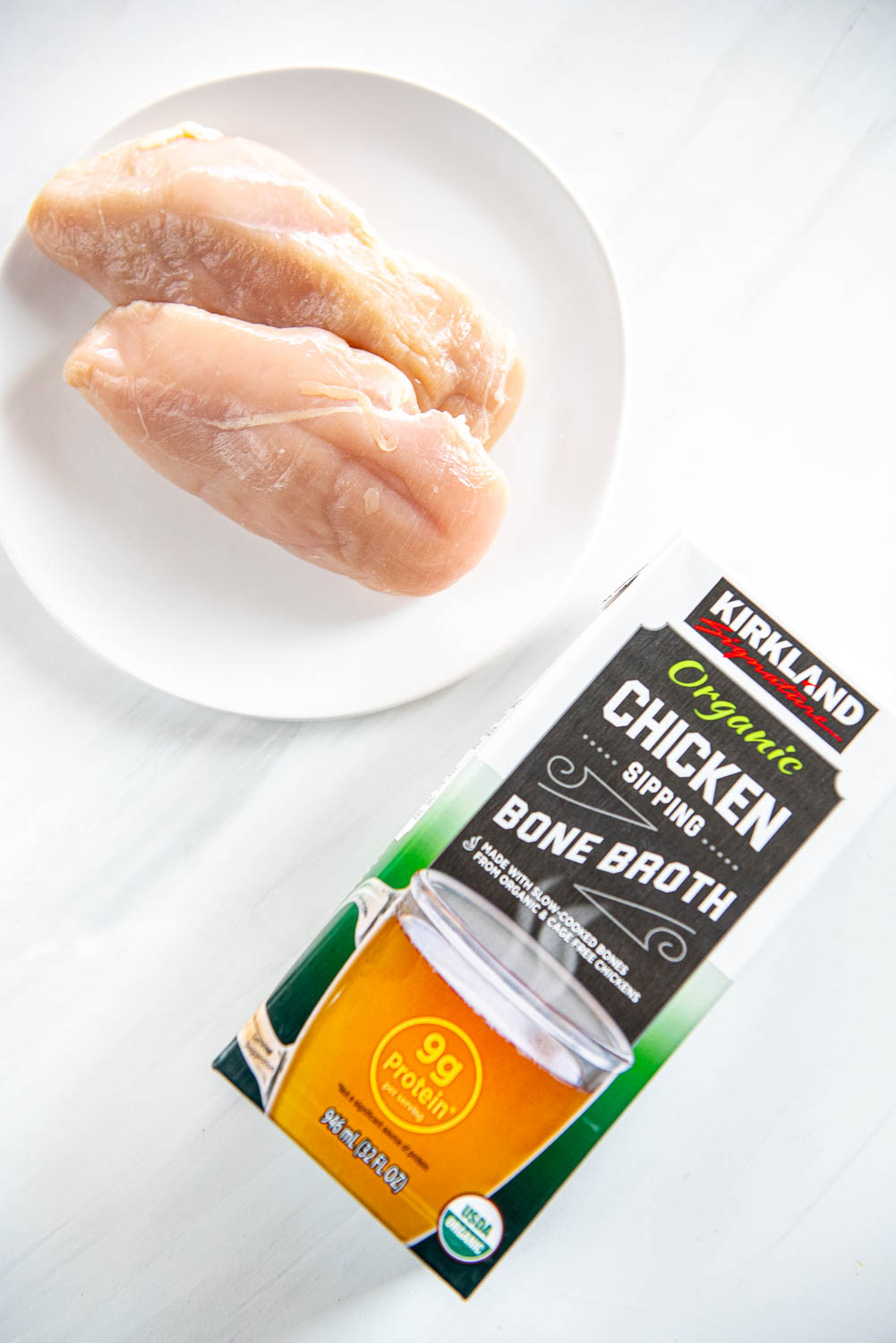 Chicken sipping bone broth 32 fl ox bottle and 2 large chicken breasts