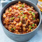 Slow Cooker Baked Beans garnished and served in bowl