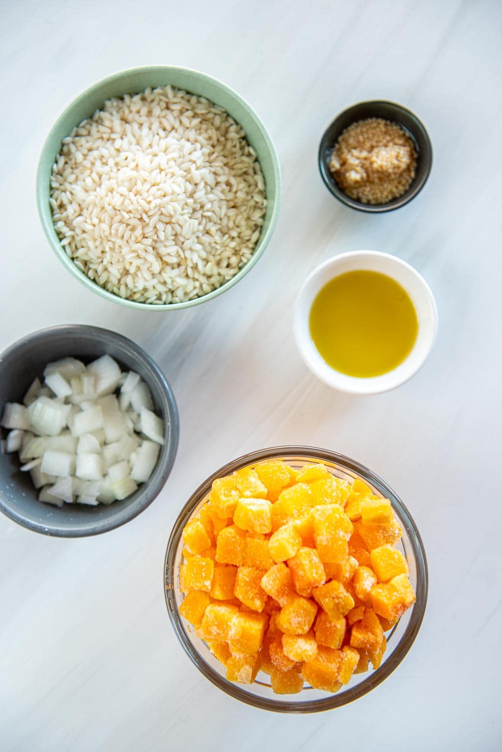 small bowls with rice, butternut squash, and spices and seasonings