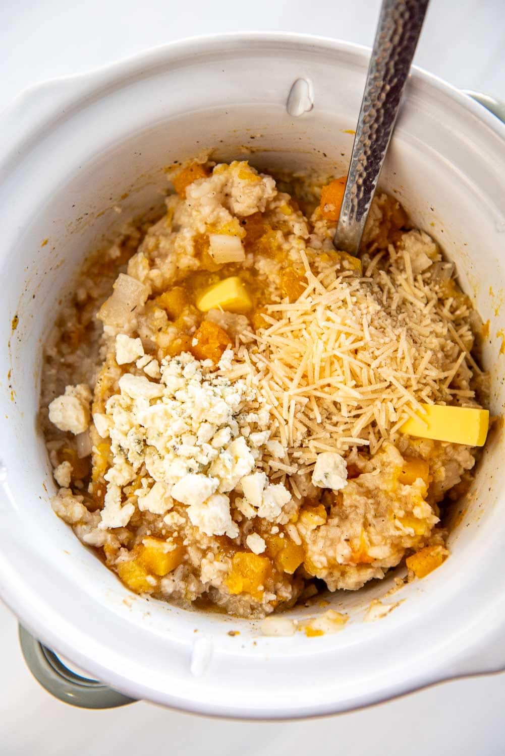Butternut Squash Risotto cooking in slow cooker with cheese on top in Slow Cooker