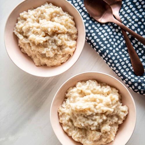 2 small bowls served with slow cooker rice pudding