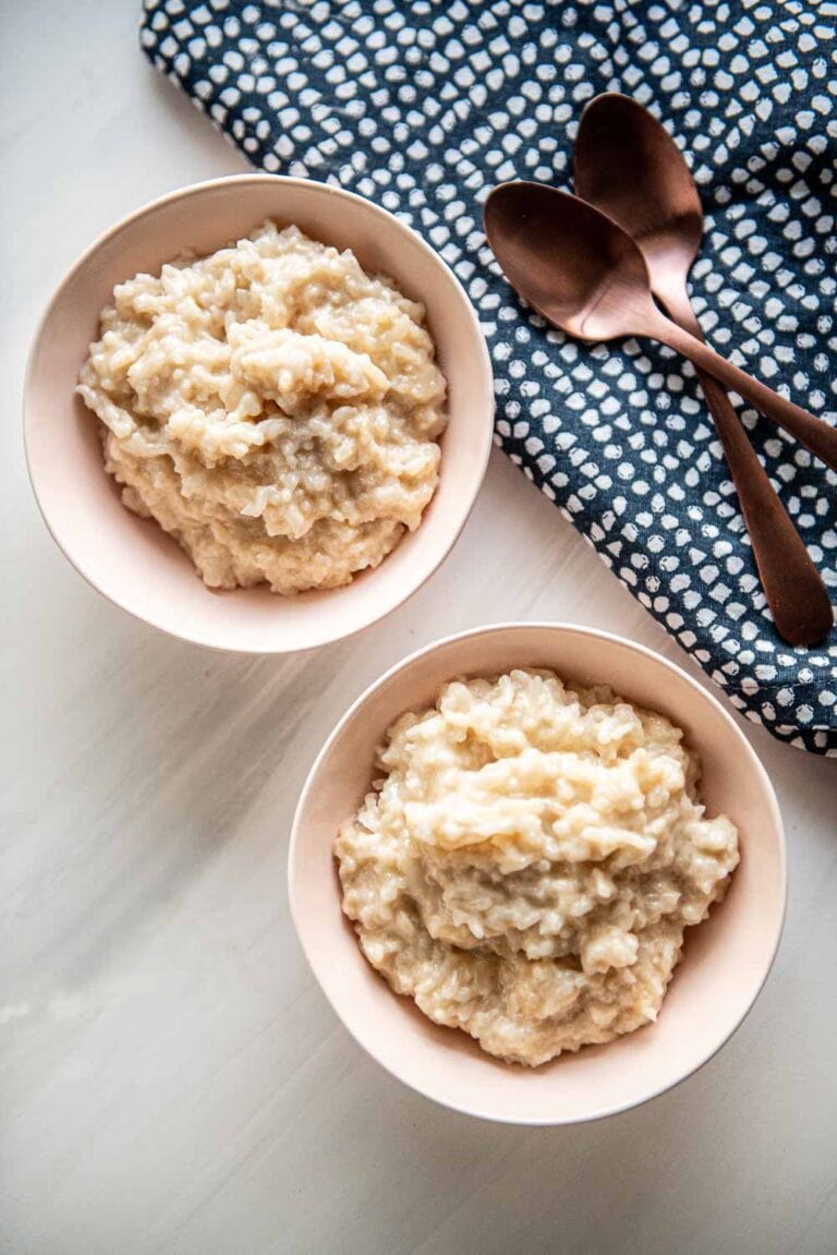 2 small bowls served with slow cooker rice pudding
