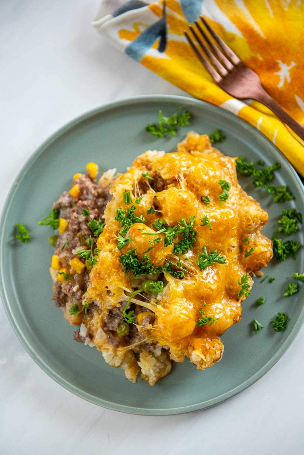 Slow Cooker Tater Tot Casserole served on plate and garnished
