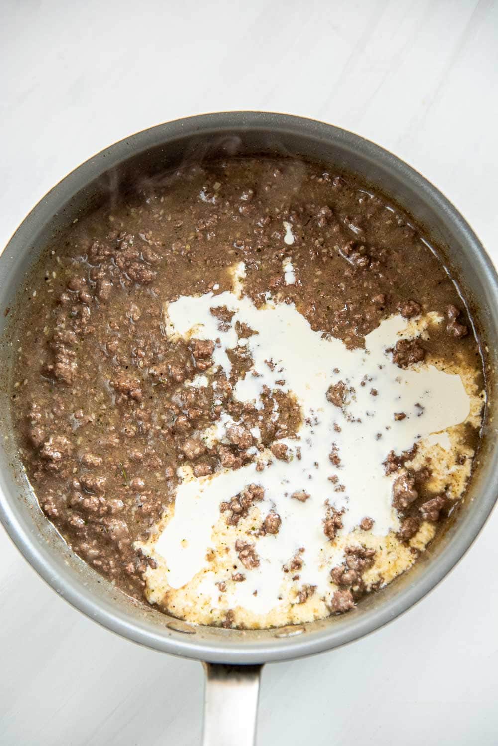 ground beef cooked and thickened and heavy whipping cream poured inside skillet