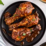 3 Slow Cooker Chicken Drumsticks served on black plate