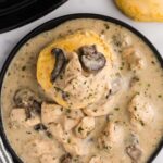 biscuit in Slow Cooker Chicken and Gravy served on plate next to fork