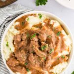 mashed potatoes topped with beed tips and garnished