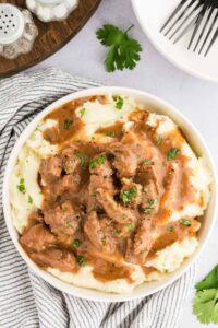 mashed potatoes topped with beed tips and garnished