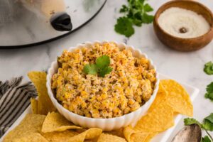 Slow Cooker Mexican Street Corn Dip served in a large bowl with tortilla chips