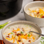 Slow Cooker Potato Soup served with bacon and chives toppings