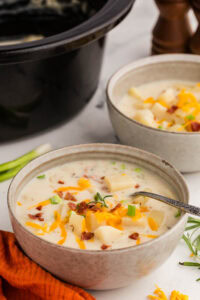 Slow Cooker Potato Soup served with bacon and chives toppings