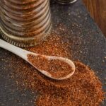 Southwest Spice Blend spilled on counter with spoonful of the seasoning laid on top