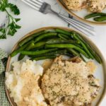 Slow Cooker Smothered Pork Chops served with green beans and mashed potatoes