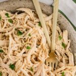 Close up image of Slow Cooker Shredded Chicken served and garnished with fork inside
