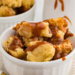 white bowl of bread pudding with caramel sauce