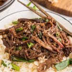 Rice and shredded Mongolian beef, garnished with freshly sliced green served on a bed of rice