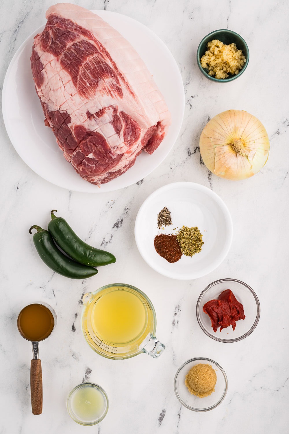 Ingredients like 4 pound pork shoulder 2 jalapeno peppers diced (ribs and seeds removed) 1 sweet onion diced 2 tablespoons jarred minced garlic 1 teaspoon oregano 1 teaspoon chili powder 1/2 teaspoon salt 1/8 teaspoon pepper 1/2 cup chicken broth 1/4 cup orange juice 1 tablespoon lime juice 2 tablespoons tomato paste 1 tablespoon brown sugar portioned and ready on counter