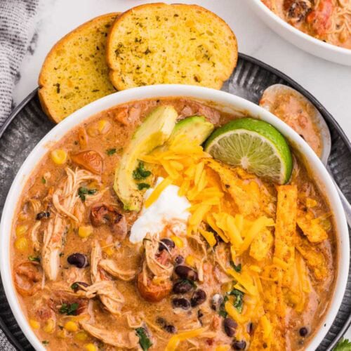 Slow Cooker Creamy Chicken Enchilada Soup served and garnished