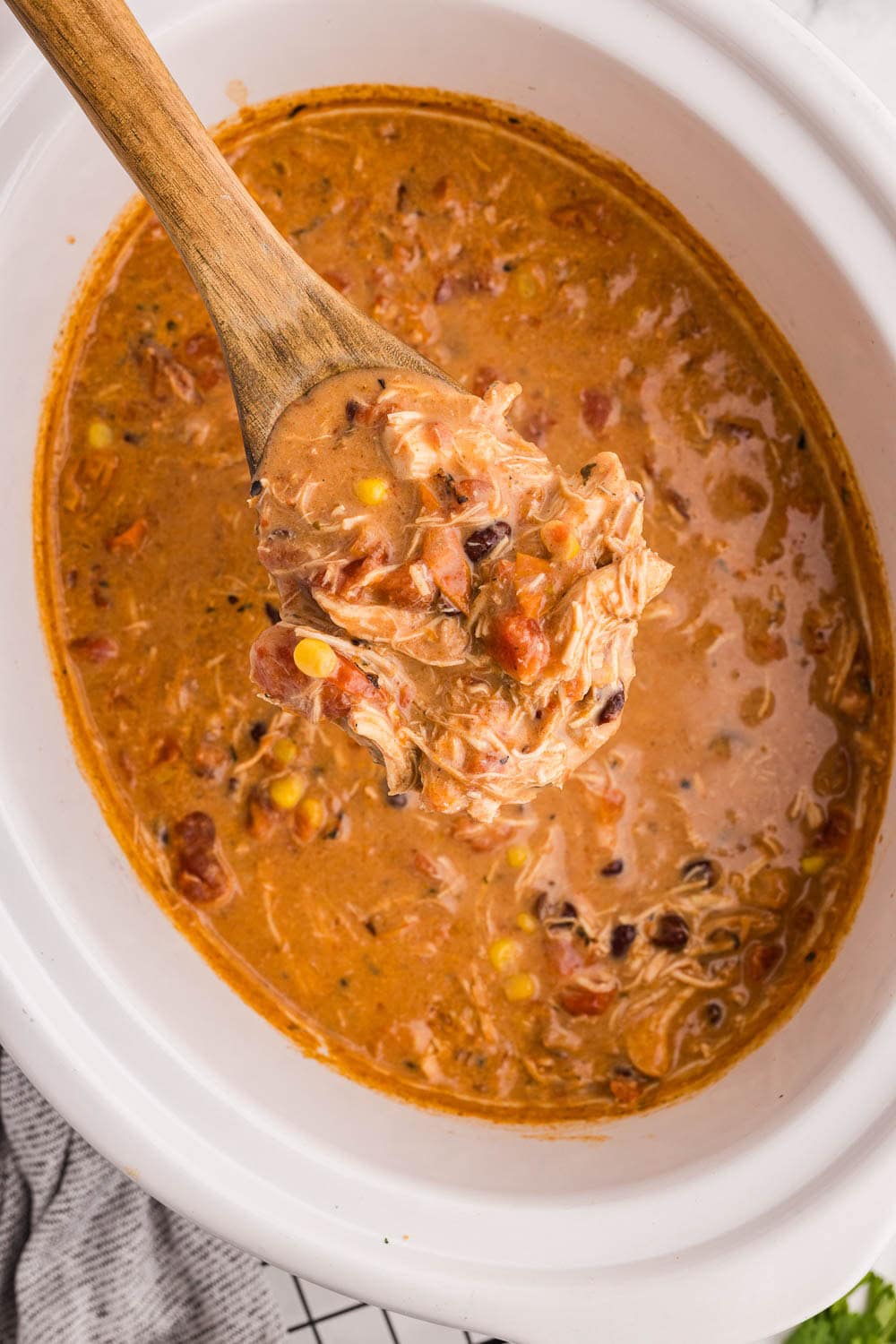 Slow Cooker Creamy Chicken Enchilada Soup cooked and ready to serve still inside of slow cooker