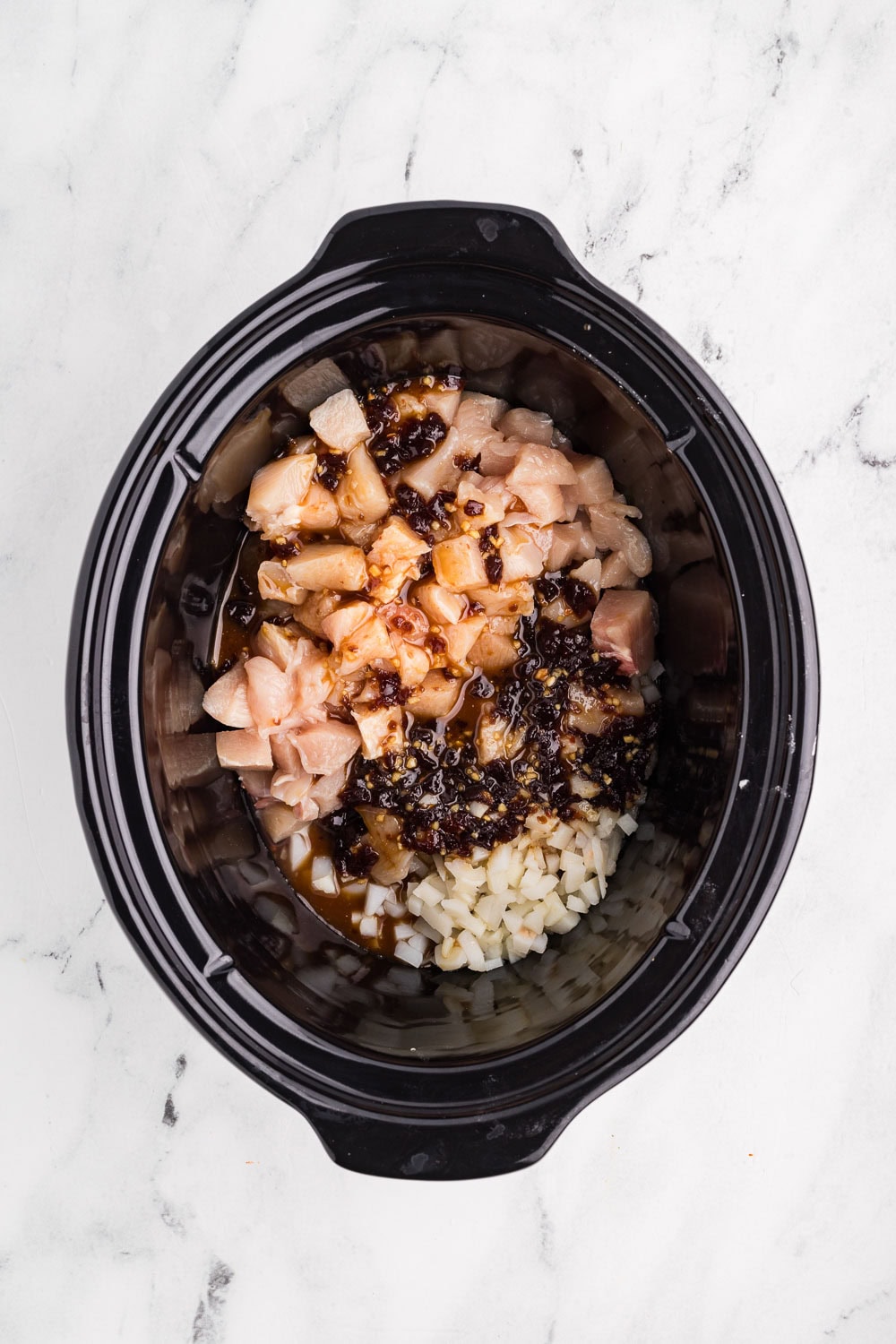 Diced chicken, honey, and onions in slow cooker