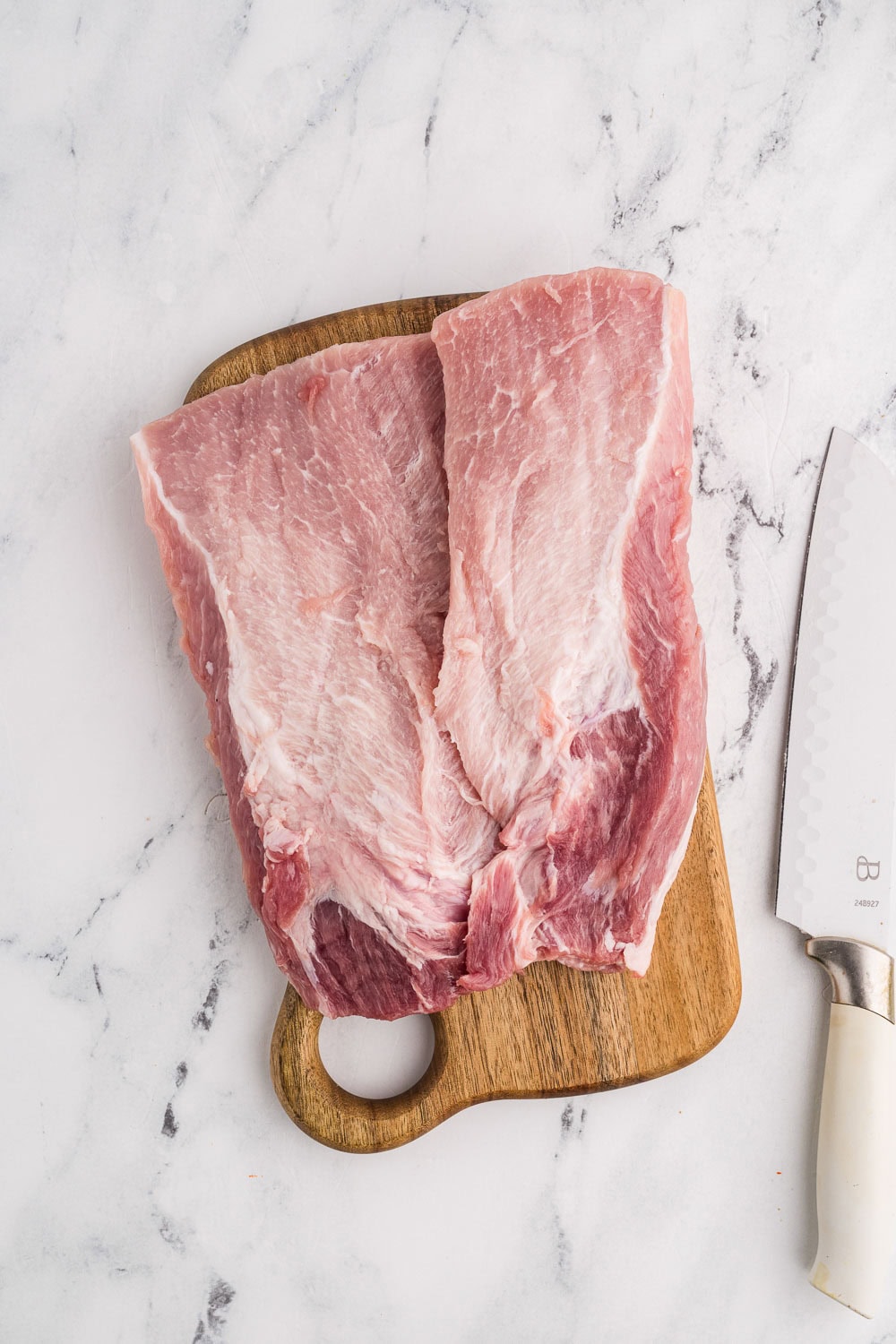 Pork Tenderloin cut butterfly on wooden cutting board