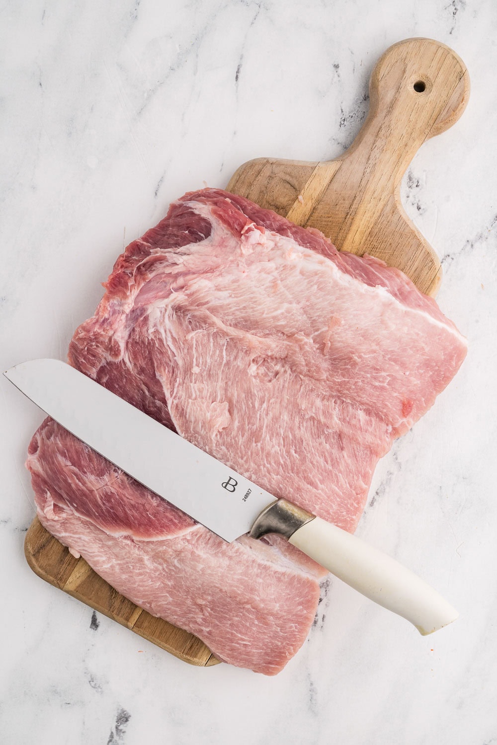 Pork Tenderloin cut butterfly on wooden cutting board