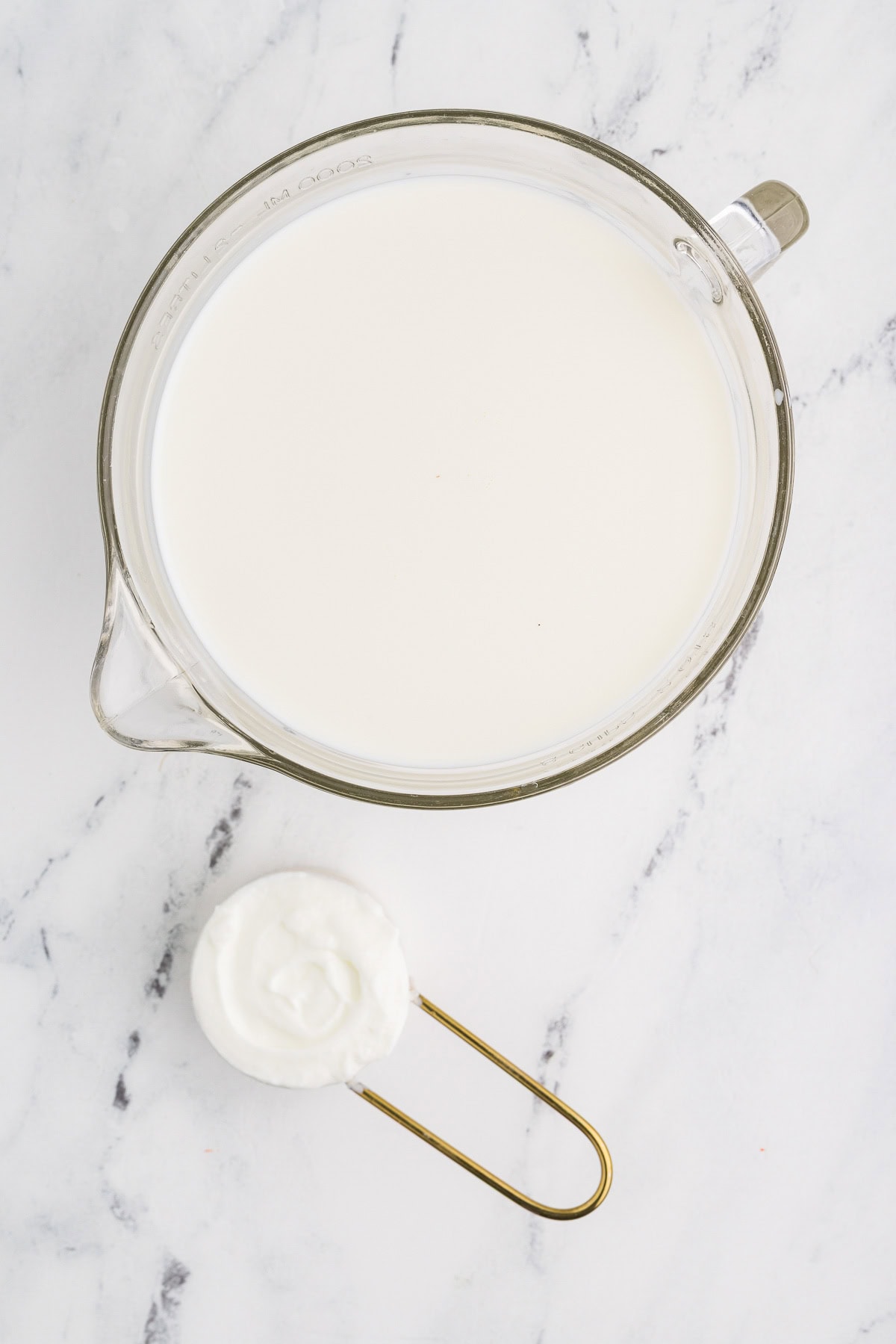 Homemade Yogurt in measuring cup being made