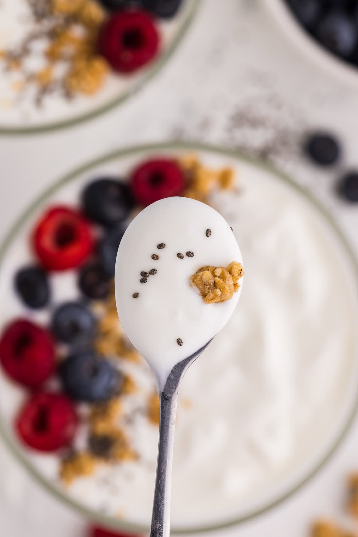 Homemade Yogurt served and garnished with berries and granola spoonful