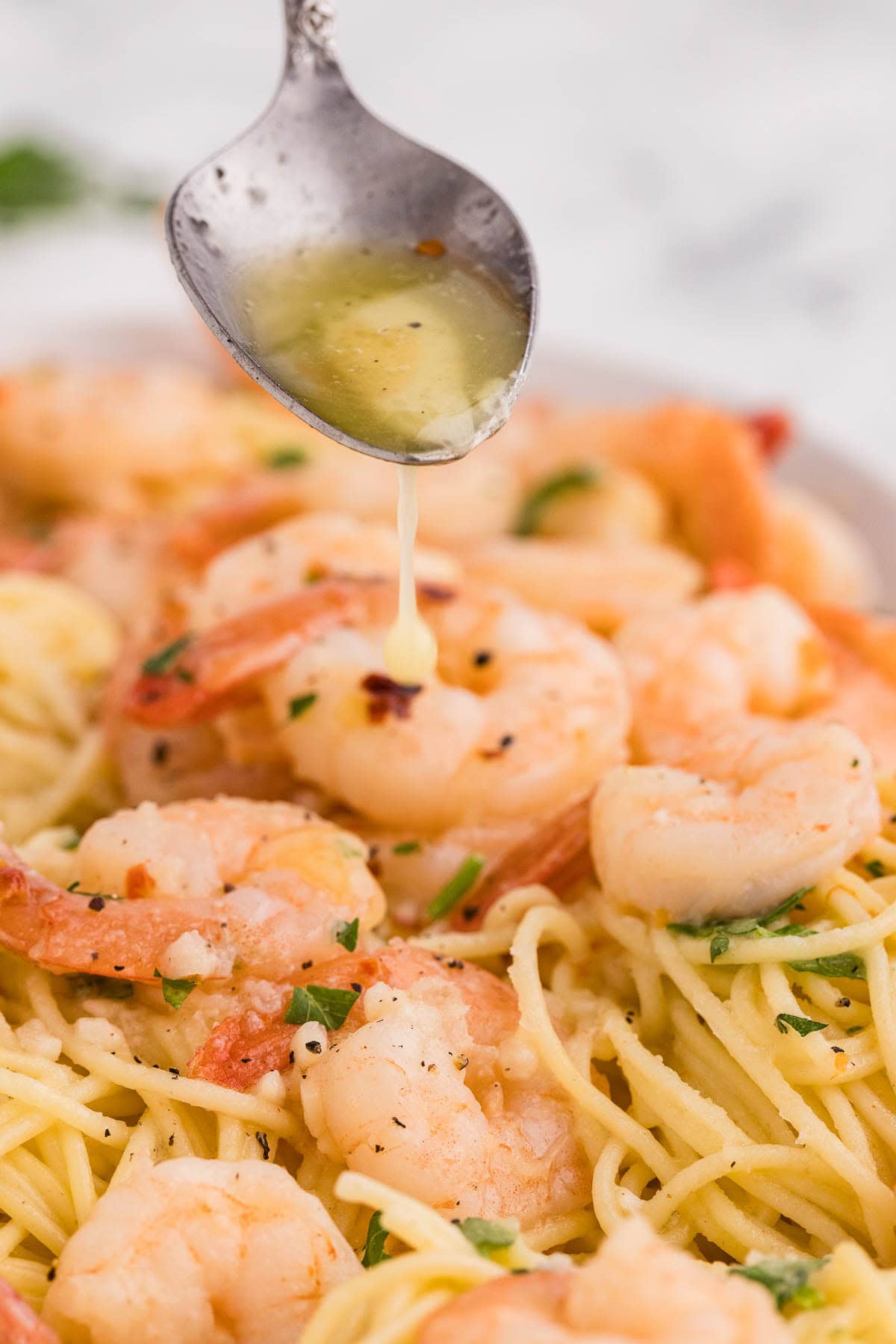 Slow Cooker Shrimp Scampi with butter being poured on top