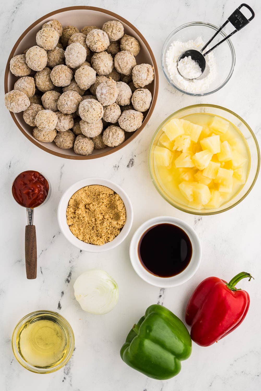 2 pounds frozen meatballs 2 bell peppers, any color ½ white onion 20 oz can pineapple chunks in juice ½ cup brown sugar ½ cup rice vinegar ¼ cup ketchup 2 tablespoons soy sauce 2 tablespoons cornstarch all laid out on counter