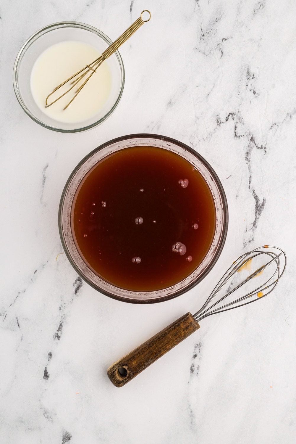 Whisking reserved pineapple juice, brown sugar, vinegar, ketchup and soy sauce