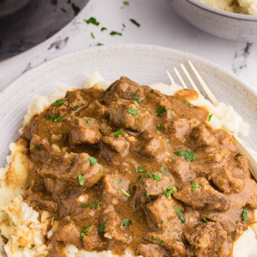Tender Slow Cooker Steak Bites served and garnished on plate